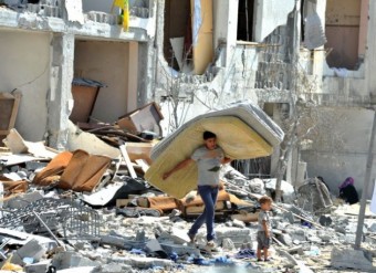 Um palestino recupera pertences de sua casa destruída em um prédio no norte da Faixa de Gaza, dia 7 deste mês. Foto: ONU/Shareef Sarnhan